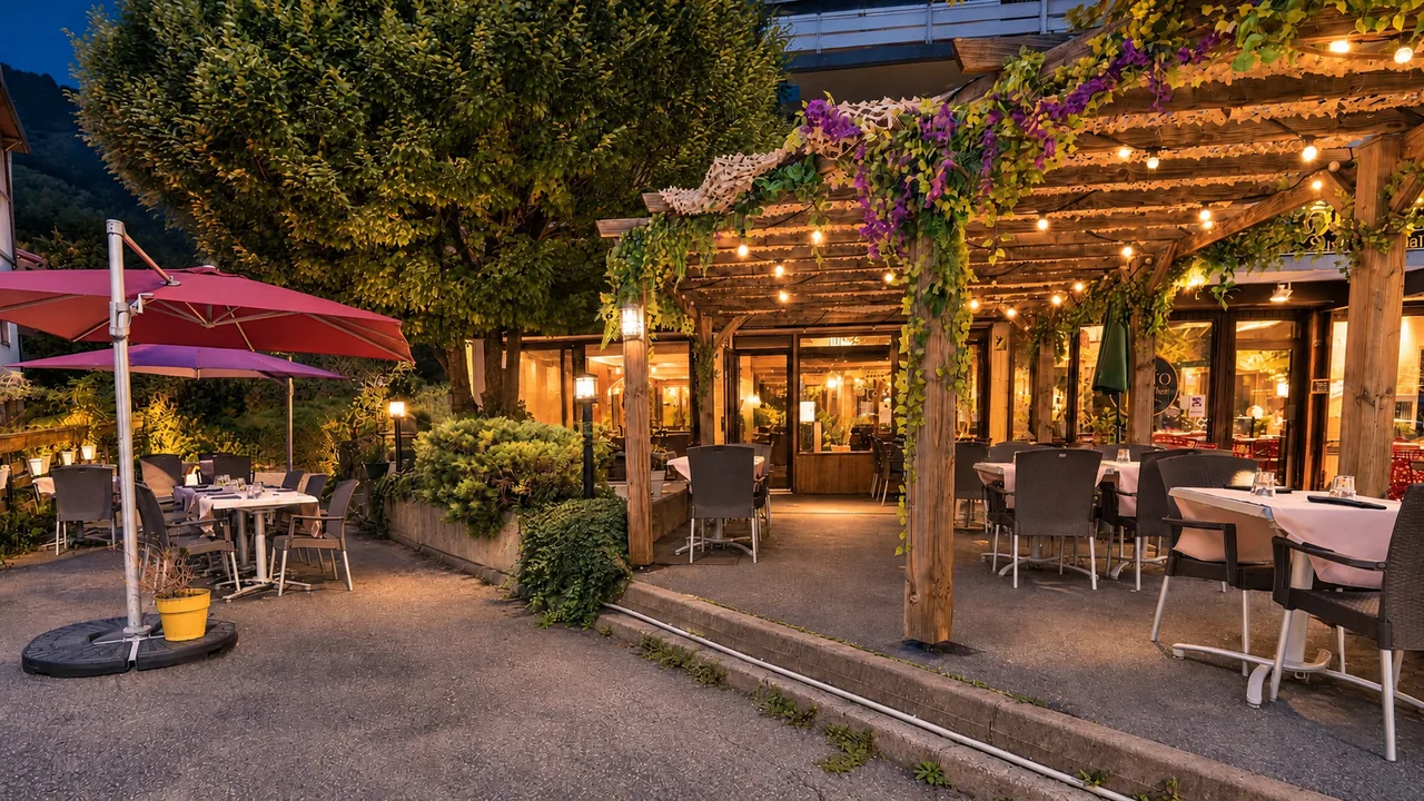 The terrace in the evening, tables laid under the parasols